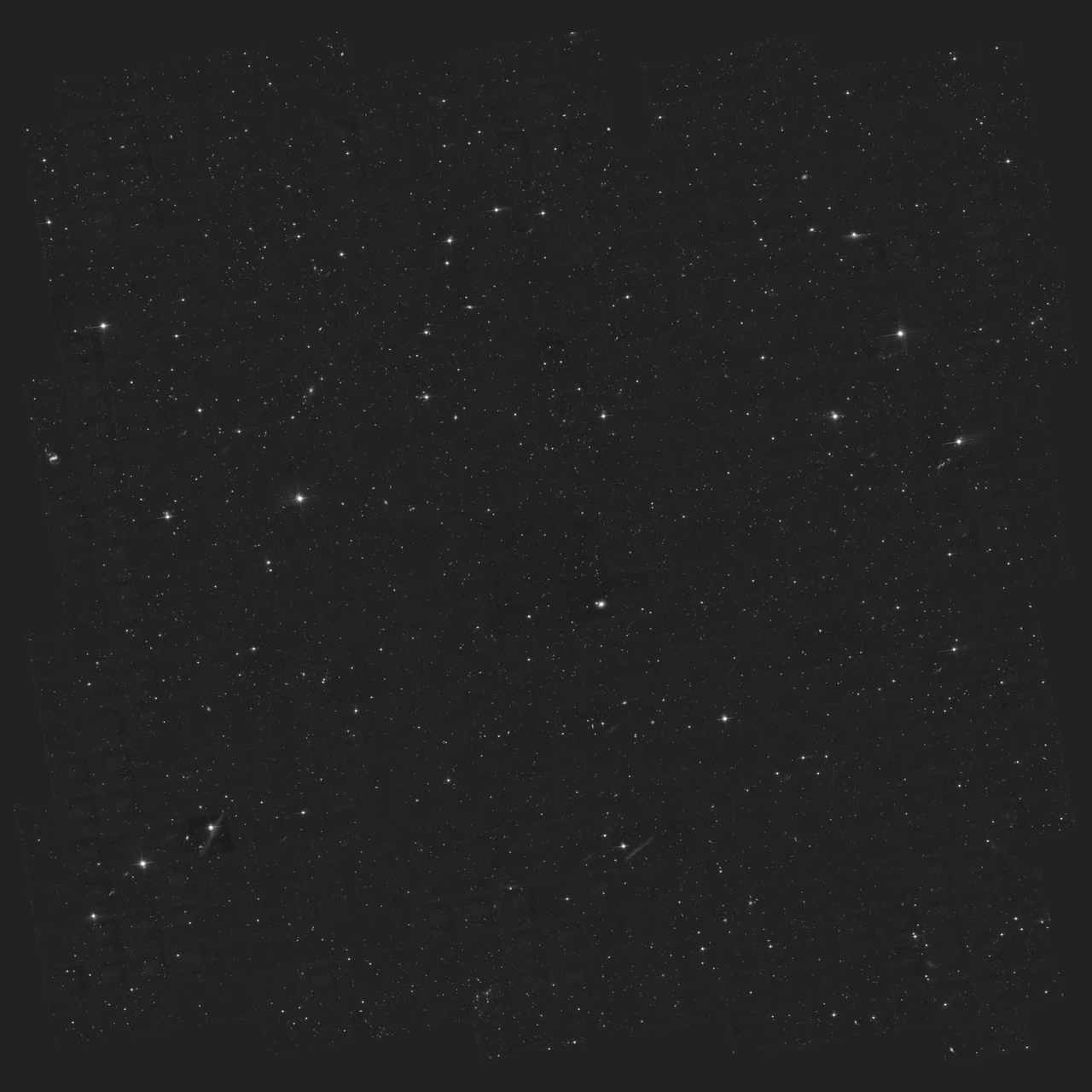 The real Hubble COSMOS deep field in Sextans, showing many distant galaxies in monochrome.